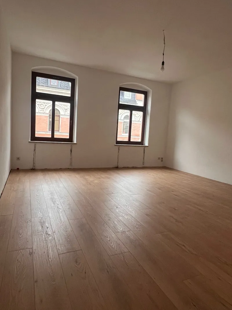 Fertiges Zimmer mit Bogenfenstern und Designboden